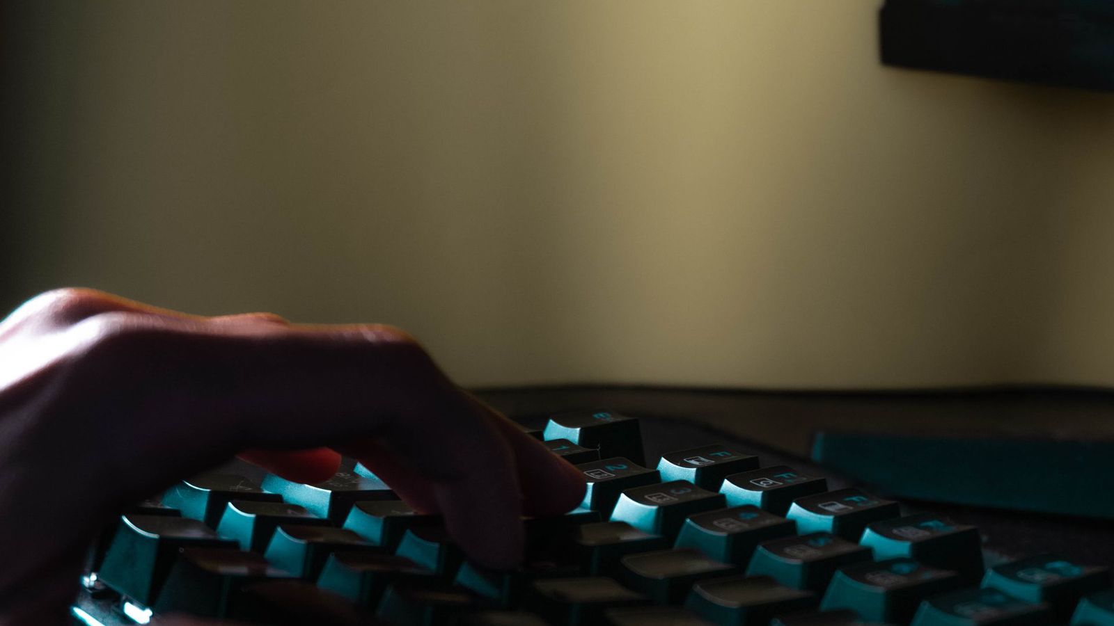 Hands typing on a laptop keyboard