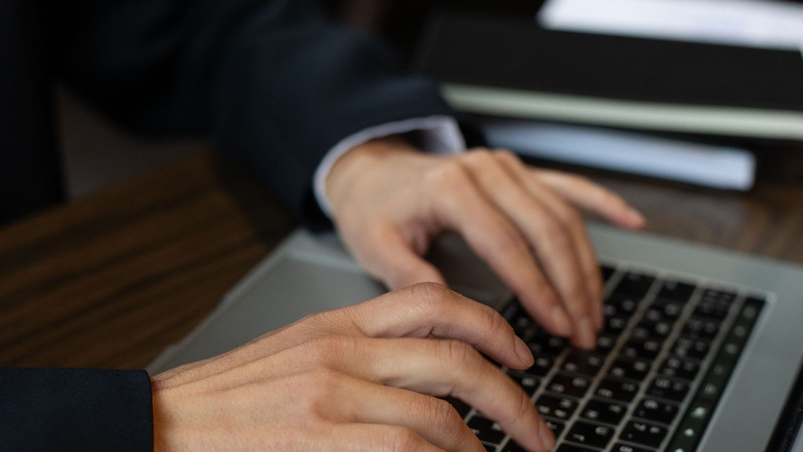 Person with headphones listening to a computer