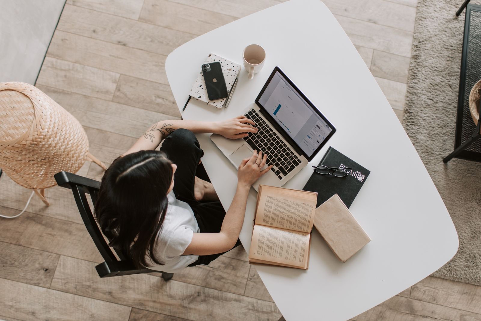 Person typing written content on a laptop at a desk