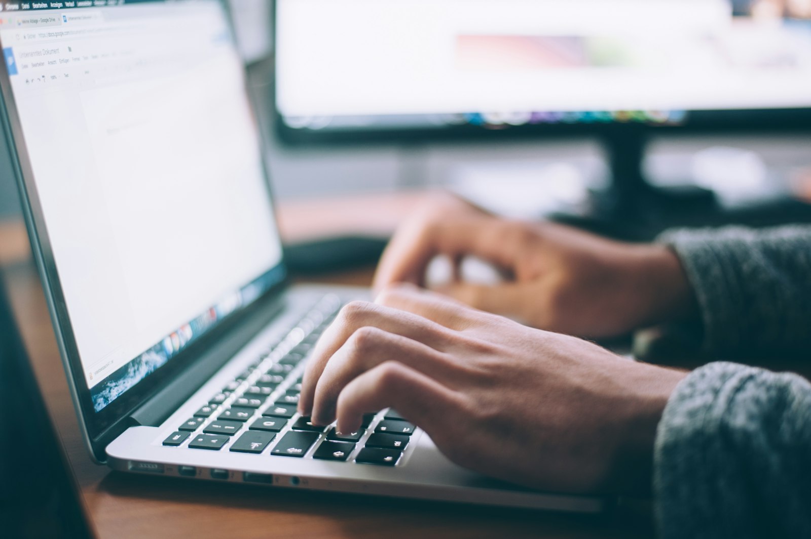 Person at a laptop writing sound recording task instructions