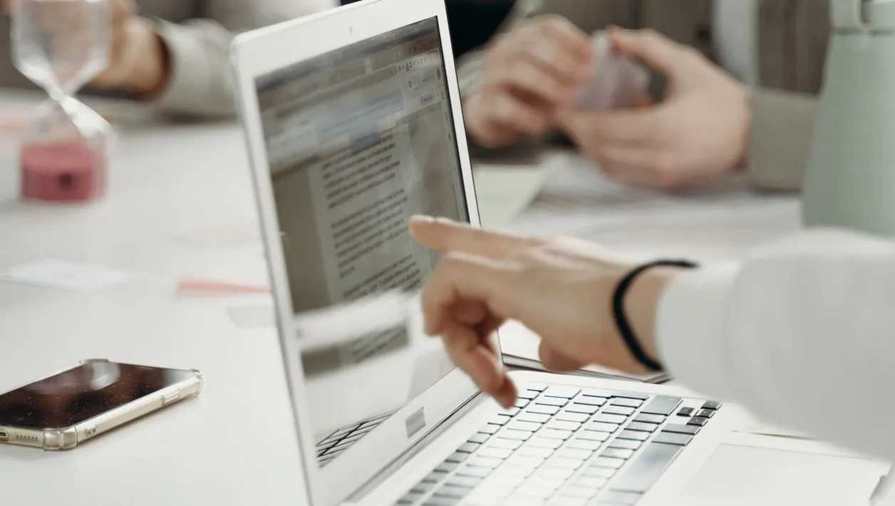 Web developer listing pages to test next to a laptop