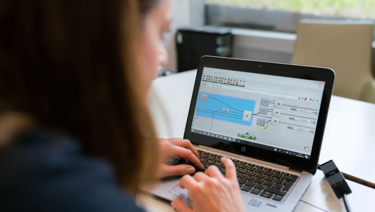 Developer comparing a website on two monitors