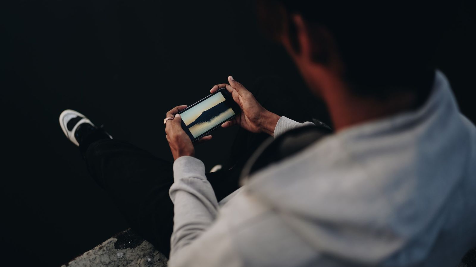 Person tapping a mobile menu on a phone