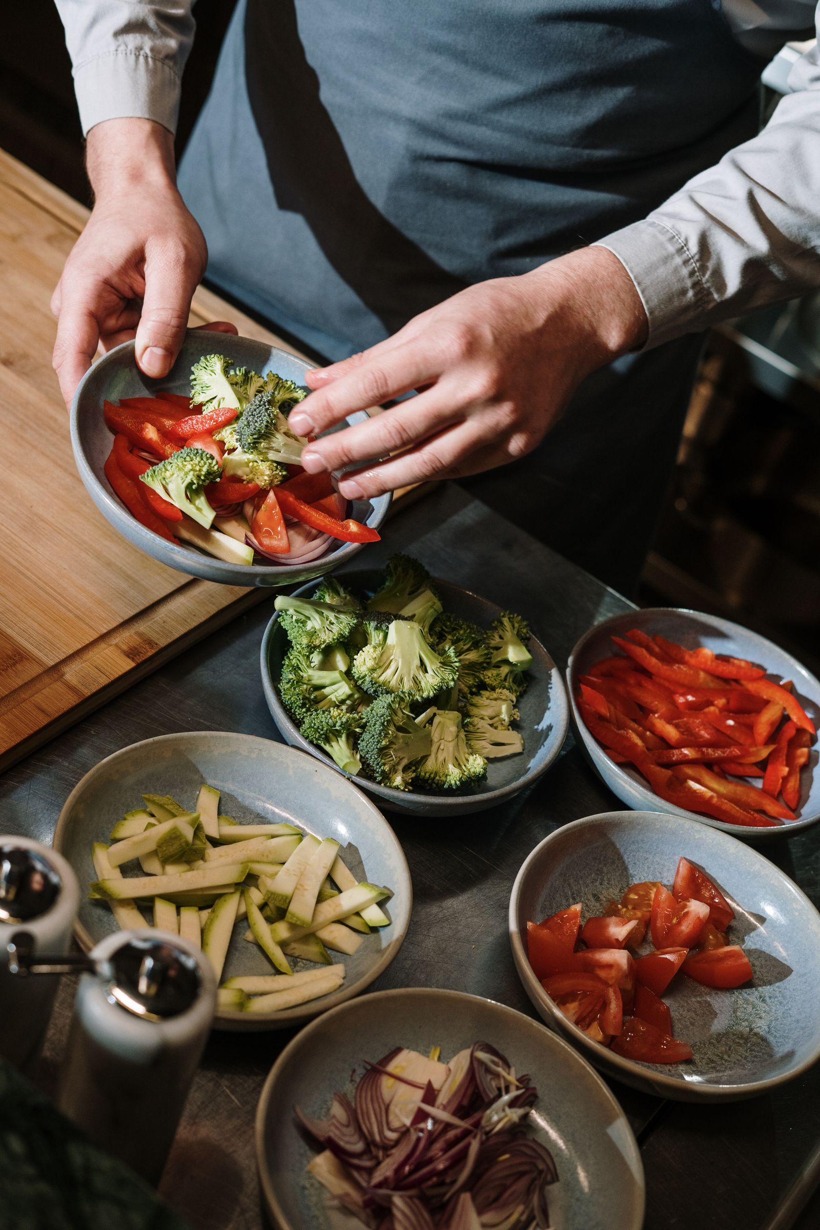 First-person view of hands cutting vegetables in a kitchen