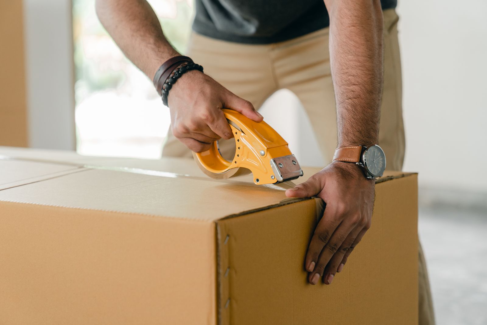 First-person view of hands packing items into a box
