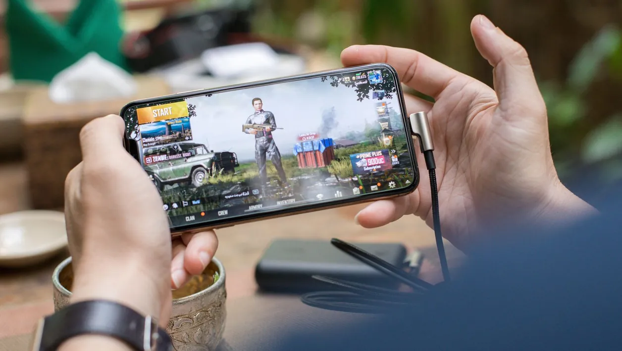Young man playing a mobile game on his phone