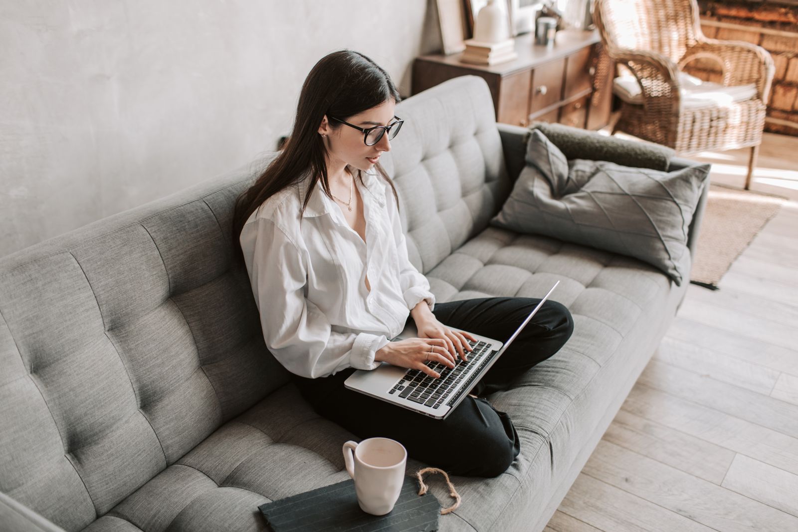 Second person checking images on a laptop at home