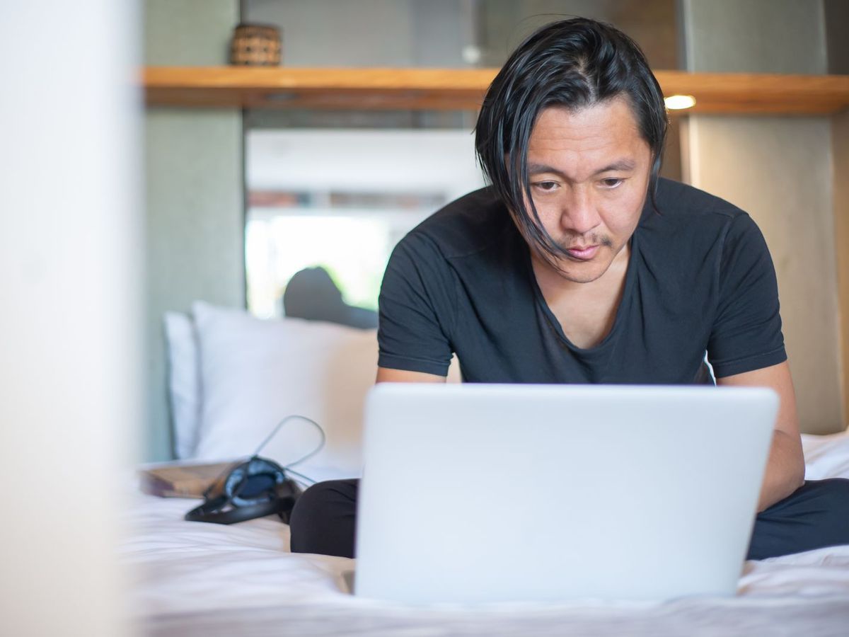 Man reviewing a recording on his laptop