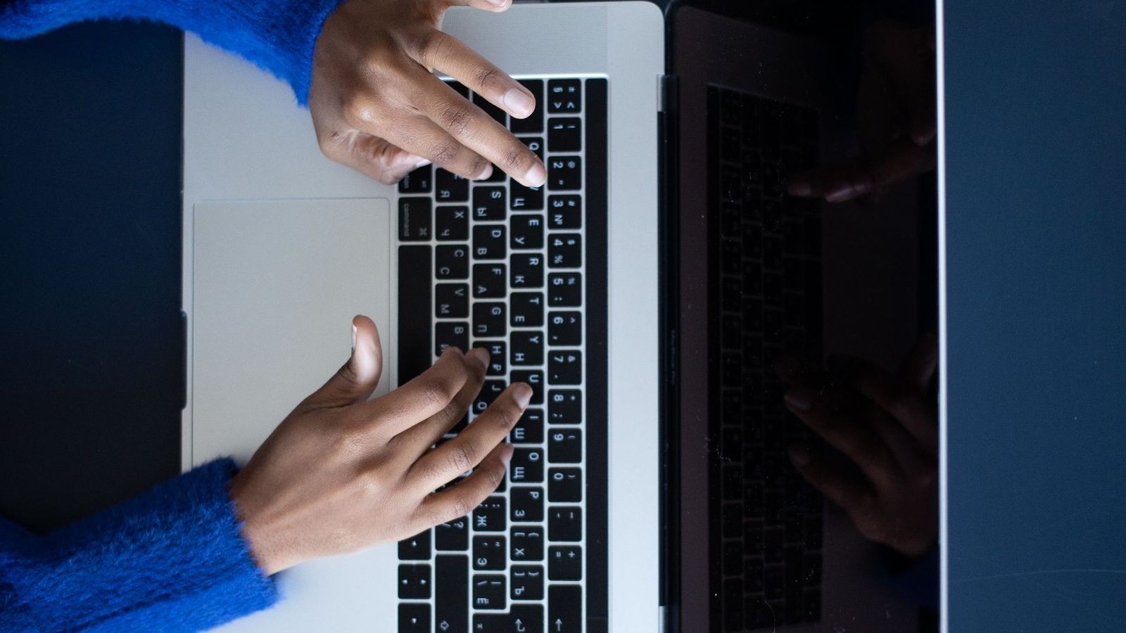 Person filling in a sign-up form on a laptop