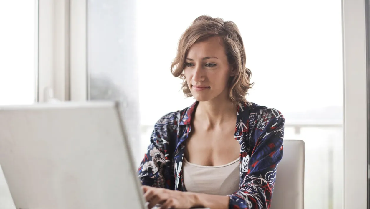 Woman trying a website on her laptop at home