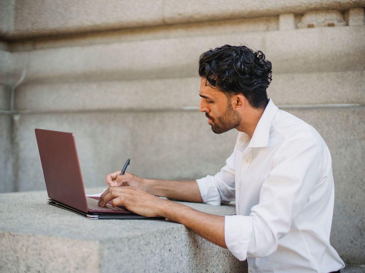 Man watching a recording on his laptop