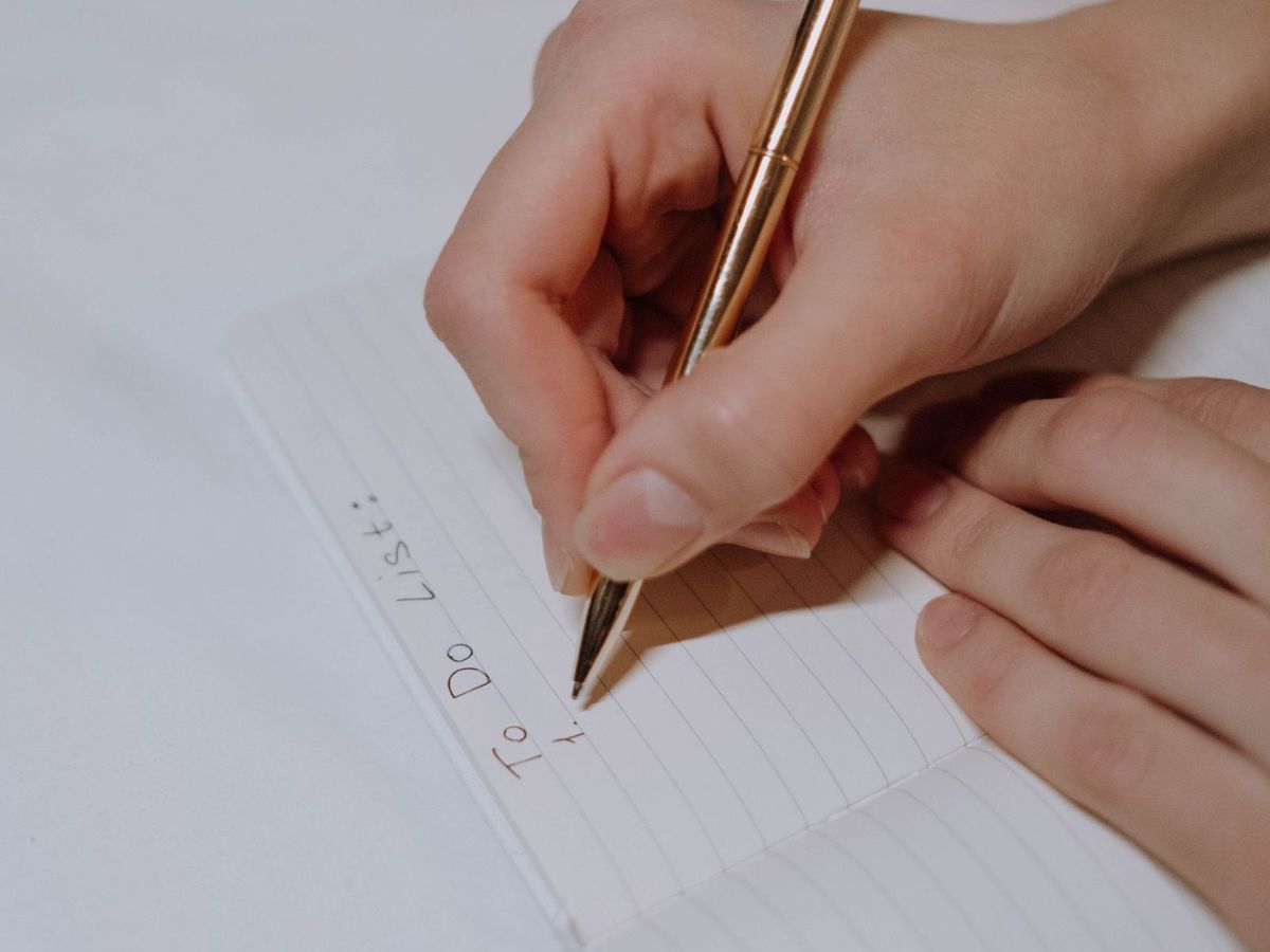 Checklist on a notebook next to a laptop