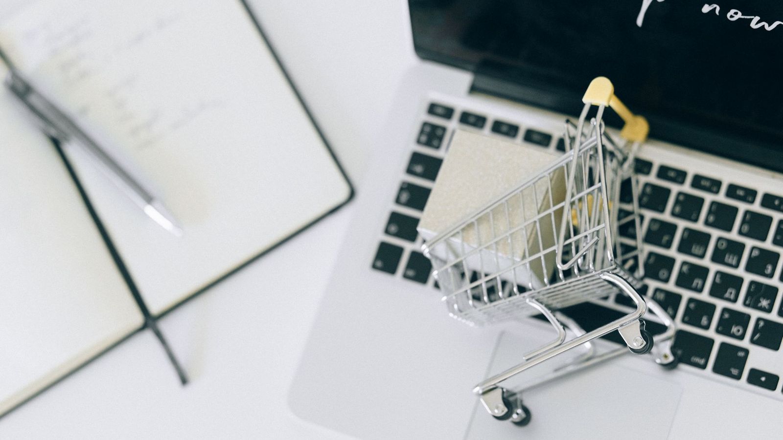 Person shopping online with a credit card and laptop