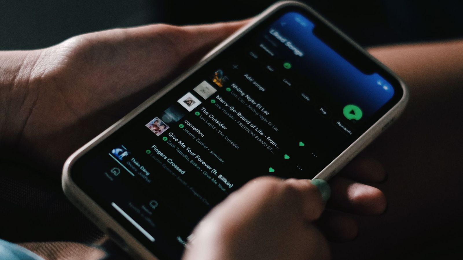 Hands holding a smartphone with an app open