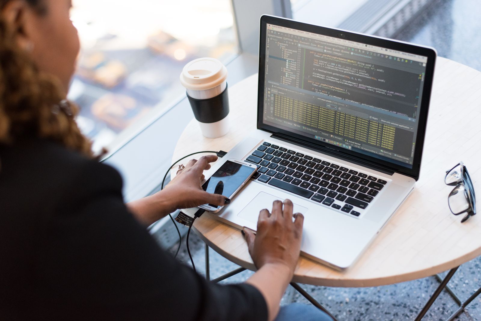 Person writing notes at a laptop to define video requirements