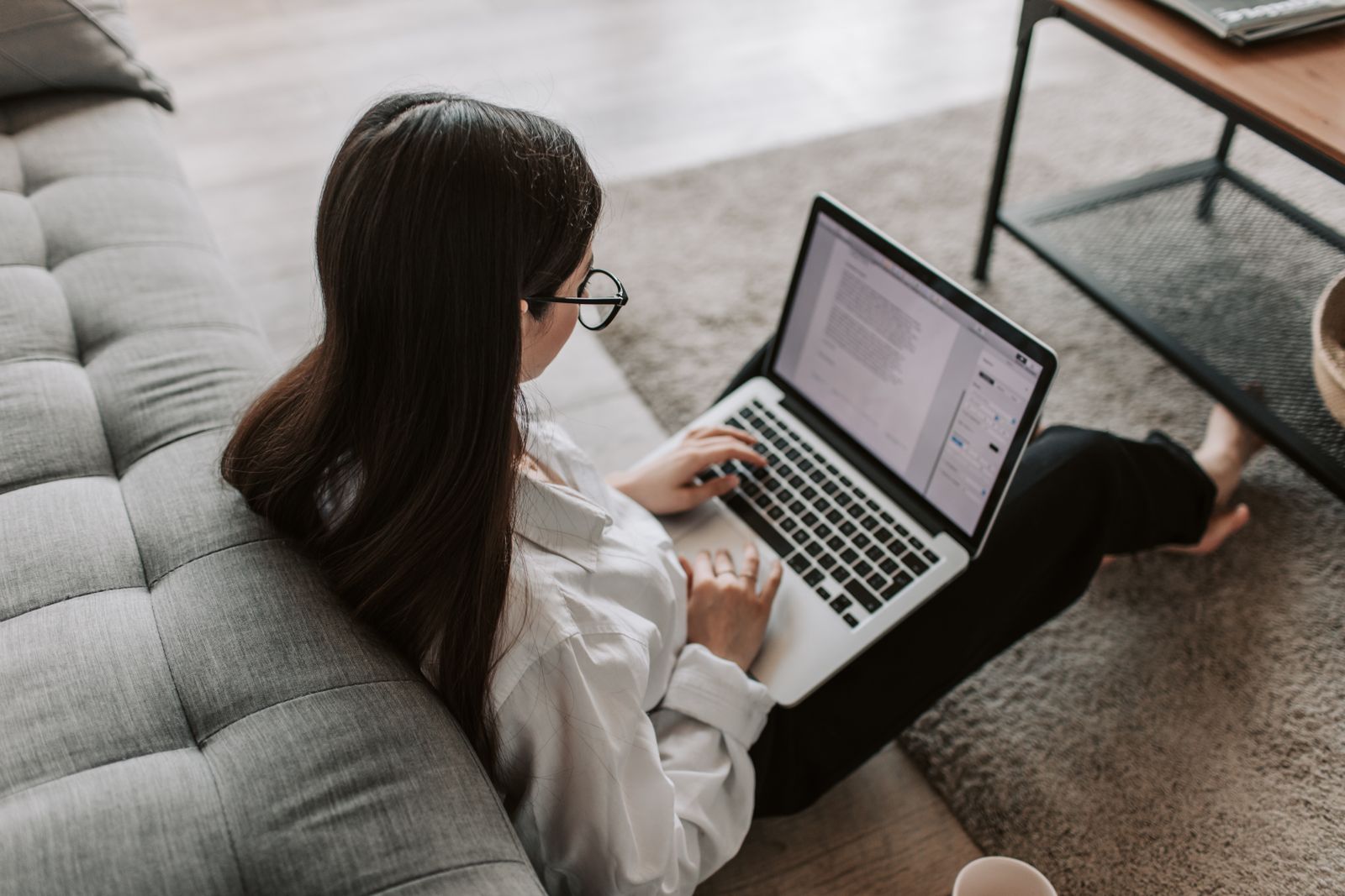 Second person checking videos on a laptop at home