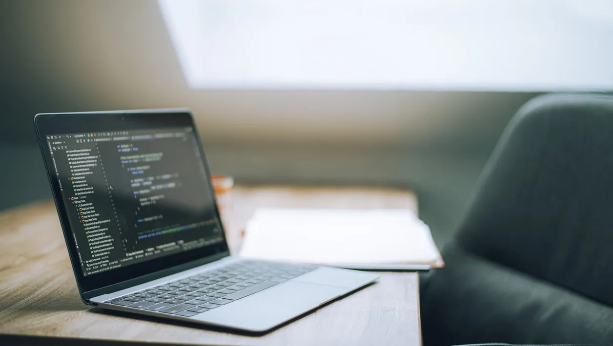 Developer fixing code on a laptop